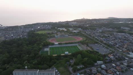 Aerial-Drone-Fly-Above-Fukui-Prefecture-Japan-City-Urban-Landscape-Soccer-Field-and-Skyline