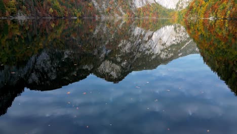 Eine-Noch-Immer-Weite-Aufnahme-Einer-Farbenfrohen-Herbstlandschaft-Mit-Einem-Ruhigen-See,-In-Dem-Sich-Das-Lebendige-Laub-Der-Umliegenden-Berge-Und-Bäume-Spiegelt