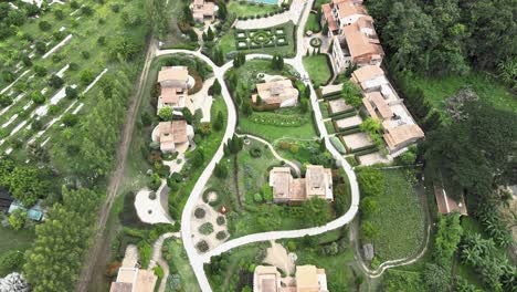 La-Toscana-Resort-Aerial-with-Revealing-Surrounding-Landscape,-Lake,-Mountainous-Hillside-in-Ratchaburi,-Thailand