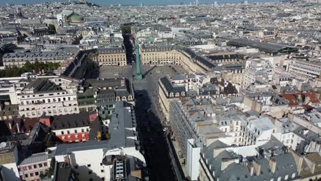 Place-Vendome-and-Paris-cityscape,-France.-Aerial-forward