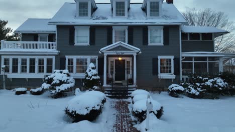Aerial-establishing-shot-of-a-stately-home-covered-in-snow