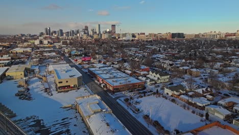 Aerial-orbit-above-industrial-outskirt-suburb-in-Denver-Colorado-at-winter-sunset