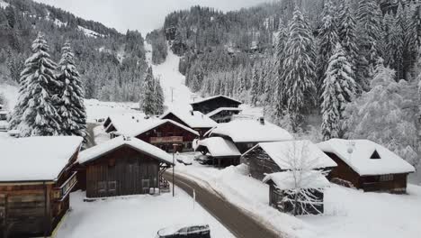 Snowy-flyover-of-a-french-ski-town-in-the-alps
