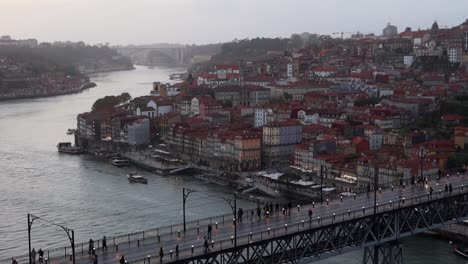 People-walking-across-Dom-Luis-I-Bridge-between-Porto-and-Gaia-at-sunset