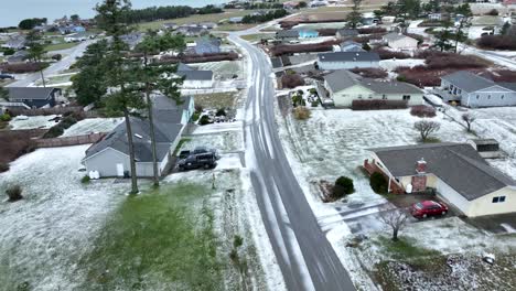 Drone-shot-of-snow-covered-streets-in-rural-neighborhood
