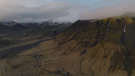 Aerial-landscape-view-of-typical-icelandic-mountain-peaks,-on-a-moody-evening