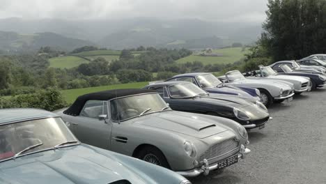 Luxury-vintage-cars-parked-with-country-landscape-in-background,-Pyrenees-Atlantiques-in-France