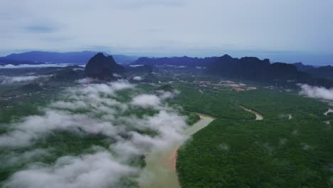 Aerial-Drone-Shot-Over-Patches-of-Cloud-with-Mangrove-Forest-Below-in-Phang-Nga-Bay,-Thailand