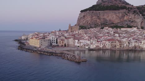 Aerial-view-of-Cefalu-medieval-city-during-summer-at-sunset,-Sicily,-Italy