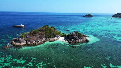 beach-rocky-cliff-island-turquoise-blue-sea