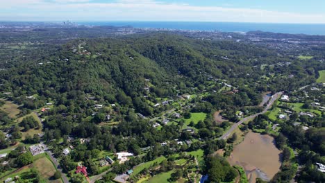 Community-Surrounded-With-Lush-Forests-In-Currumbin-Valley,-Gold-Coast,-QLD,-Australia---Aerial-Drone-Shot