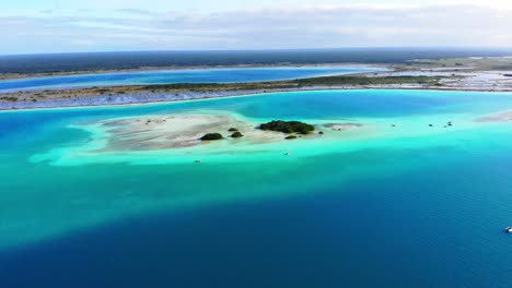 Turquoise-Lagoon-with-Surrounding-Blue-Waters-at-Laguna-De-Los-7-Colores-in-Mexico-from-an-Aerial-Drone-View