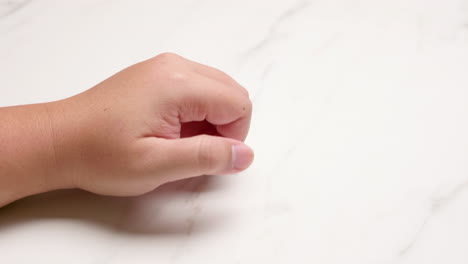 Close-up-of-hand-knuckle-knocking-on-a-surface-of-a-wall