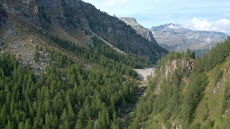 Mountain-valley-with-lush-greenery-and-clear-skies-at-Lago-di-Devero,-Alpe-Devero,-aerial-view