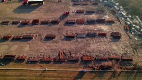 Overview-aerial-of-a-forklift-driver-loading-steel-bars-for-a-red-Semi-Conestoga-truck-driver