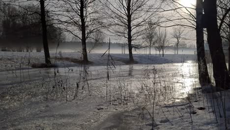 Misty-peaceful-winter-scenery,-frozen-stream-and-foggy-valley,-calm-landscape
