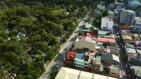 Drone-overview-of-cars-on-the-South-Avenue-of-Makati-city,-Manila,-Philippines