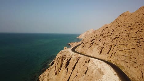 aerial-shot-erosion-mountain-rock-cliff-landscape-of-marine-adventure-coastal-road-seaside-beach-skyline-panoramic-wonderful-horizon-in-Persian-gulf-Iran-Arabian-hospitality-road-trip-travel-peaceful