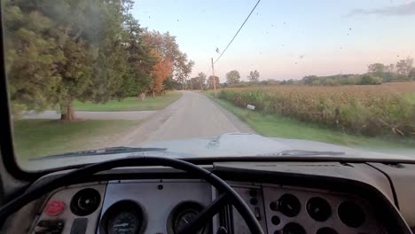 Driving-old-truck-on-gravel-road-of-rural-America,-POV-view