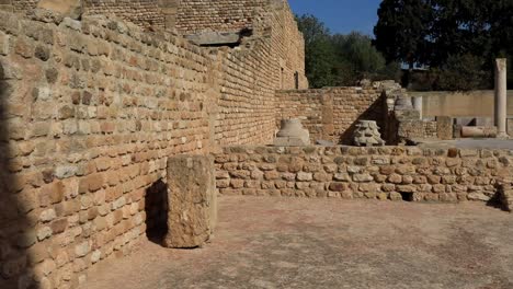 Sunlit-ancient-Roman-ruins-at-Carthage,-Tunisia,-clear-blue-sky