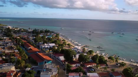 Aerial-pan-right-peaceful-fishing-town-caribbean-sea-island,-sunset-time-Los-Roques