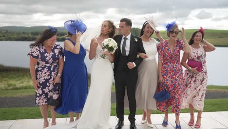 Mothers-of-bride-and-groom-join-the-happy-couple-with-others-for-photos