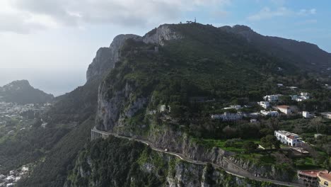 Toma-Aérea-De-Capri,-Italia,-Mostrando-El-Paisaje-Montañoso-Y-La-Arquitectura-Costera,-Día-Soleado