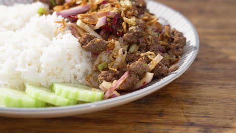 National-dish-of-Laos-Beef-Larb-plated-with-sticky-white-rice,-slider-close-up-4K
