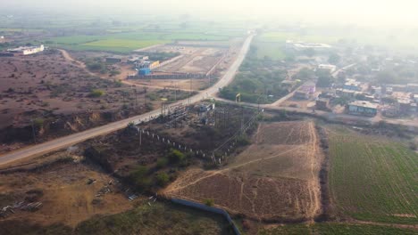 Aerial-drone-shot-of-a-small-capacity-electricity-or-power-plant-along-a-village-road-in-Madhya-Pradesh-India