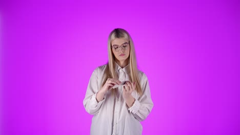 Calm-Caucasian-Blonde-Lady-with-Serious-Attitude-File-her-Nails-in-Studio-Chroma-Background-Islolated-torso-Shot-with-Glasses