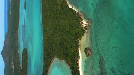 Aerial-view-of-forested-island-off-Isle-of-Pines-coast