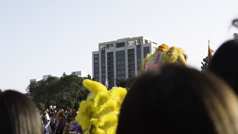 Vibrant-Chinese-lion-dance-performance-with-spectators,-daylight-in-Taipei