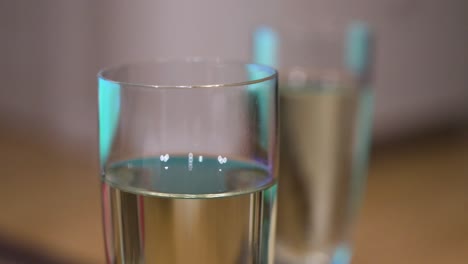 A-narrow-focus-view-of-a-Champagne-drink-and-glasses-stand-on-a-tablet