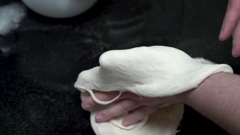 Close-up-of-hands-kneading-the-dough-to-make-pizza-in-slow-motion