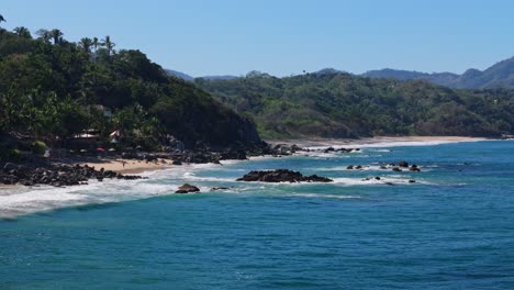 Palya-Carricitos-in-Sayulita-Mexico-seen-by-a-low-flying-drone-across-the-water