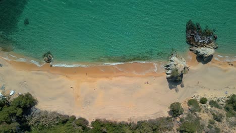 Explore-the-beauty-of-Lloret-De-Mar-and-the-tranquility-of-Cala-Canyelles-from-a-bird's-eye-view,-amidst-the-stunning-scenery-of-Costa-Brava