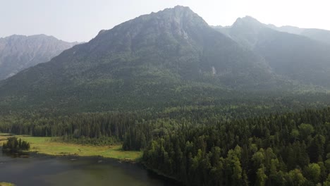 Scenic-Landscape-Across-Seeley-Lake-Provincial-Park-with-Views-of-Stegyawden-Mountain-Covered-with-Alpine-Forest-Trees-from-an-Aerial-Drone