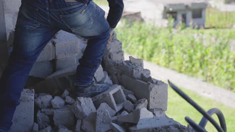 bricklayer-tearing-down-a-wall