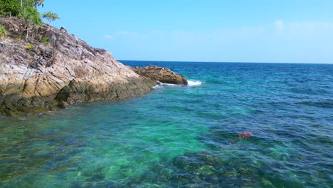 Crystal-clear-water-on-rocky-sandy-thai-island-beach