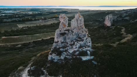 Drone-retreat-and-pan-up-across-magnificient-countryside-from-blank-rock,-Provence-France