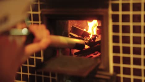 Old-Fashioned-Japanese-Wood-Fire-Stove,-Blowing-Oxygen-into-the-Flames-4k