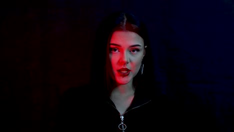 Close-up-portrait-of-a-beautiful-Caucasian-model-singing-in-red-light-in-front-of-black-background