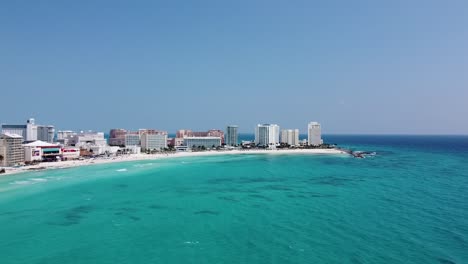 Cancun-coastline-with-clear-turquoise-waters-and-beachfront-hotels,-aerial-view