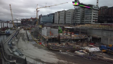 Large-construction-site-at-Slussen-in-Stockholm,-buildings-in-background