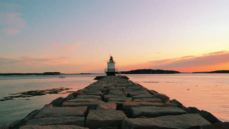 Sunrise-at-Spring-Point-Ledge-Lighthouse-with-serene-sky,-showcasing-beautiful-orange-and-yellow-clouds