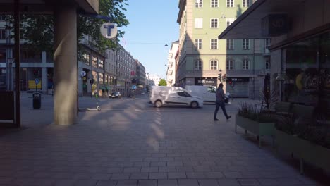 Man-walks-by-trafficked-street-in-Stockholm-at-Palme's-death-place