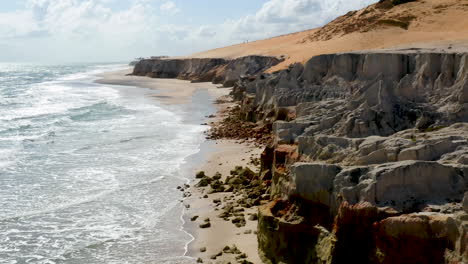 Aerial-view-of-the-broken-stones-in-Morro-Branco-beach,-Ceara,-Brazil