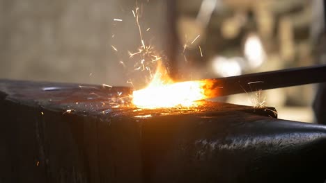 blacksmith-hits-hot-iron-and-sparks-fly