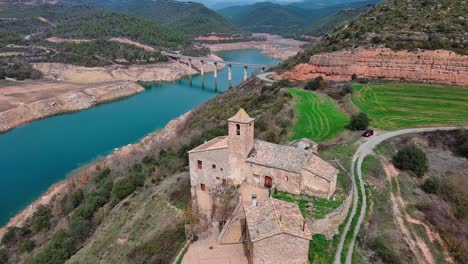 Flying-over-Rialb-tower-buildings-and-river,-Lleida-in-Spain