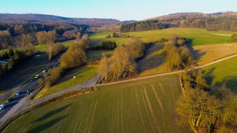 Picturesque-Aerial-View-of-a-Rural-Road-Winding-Through-Autumn-Fields